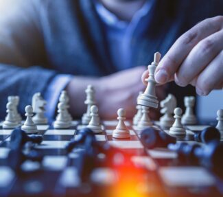 Chess board with fingers on one piece