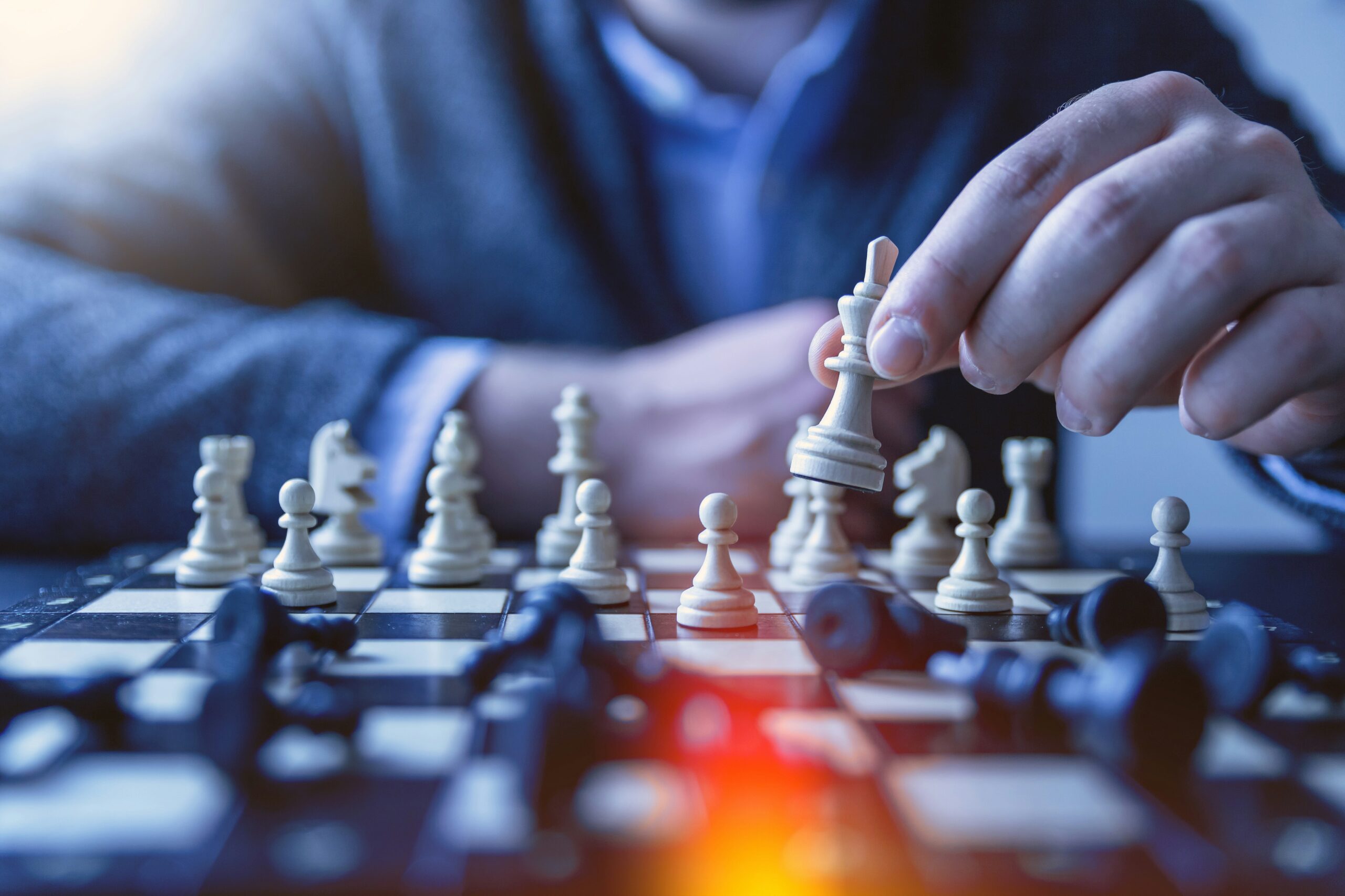 Chess board with fingers on one piece