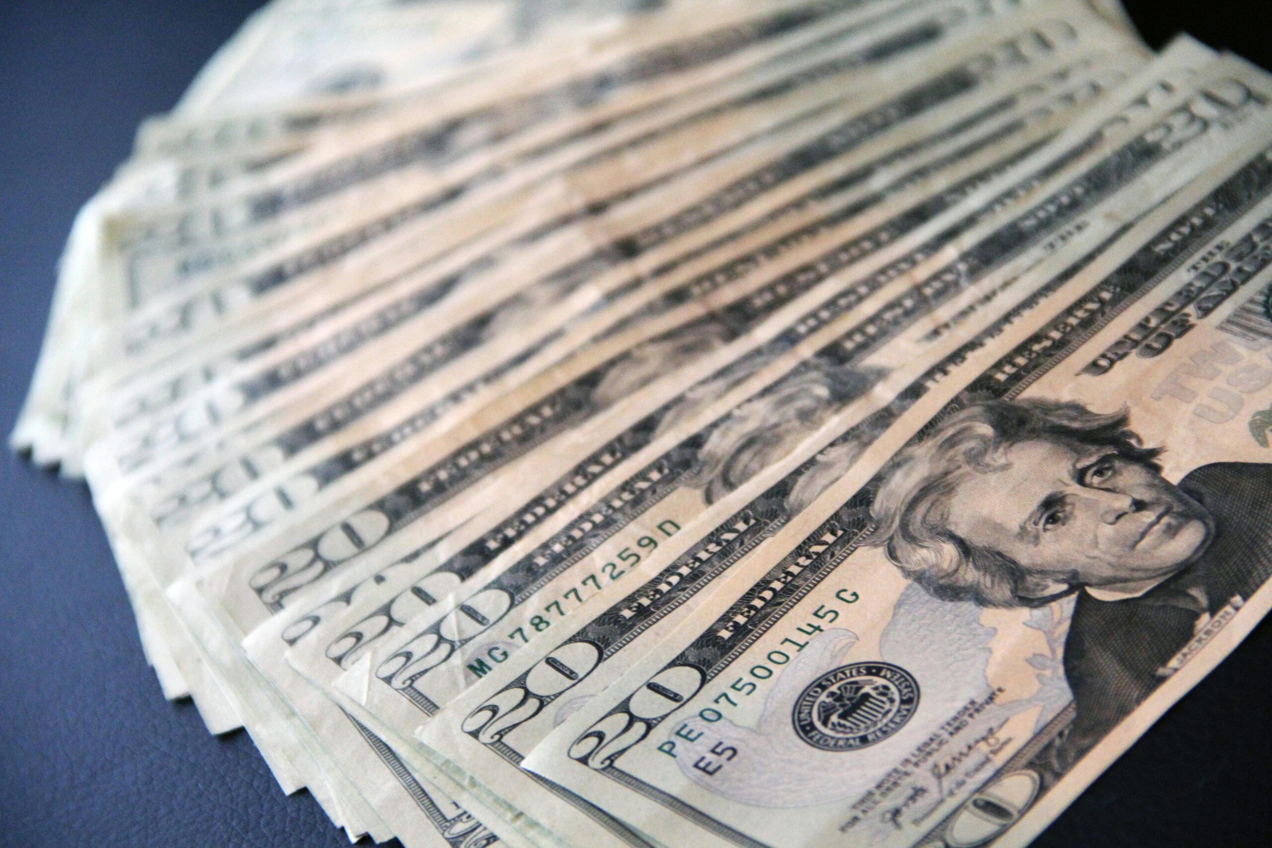 US $20 notes spread on a table
