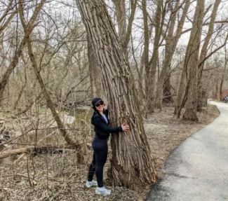 Author Jen Armel with tree in forest