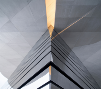 Abstract image of skyscraper peering towards a golden sky