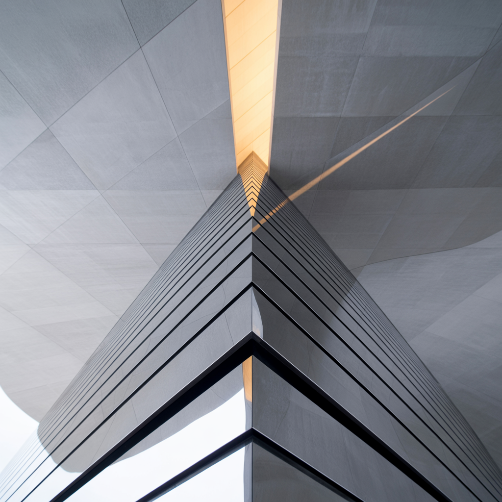 Abstract image of skyscraper peering towards a golden sky