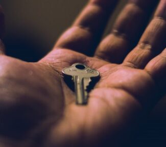 Image of a key in the palm of a hand