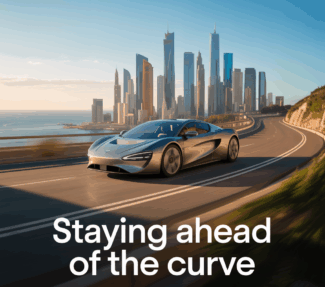 Car driving on curve with skyline of futuristic major city in background with caption "Staying ahead of the curve"